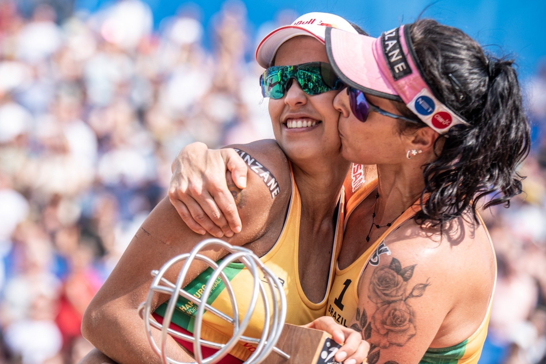 Agatha gives her teammate a kiss after picking up the World Tour Finals title